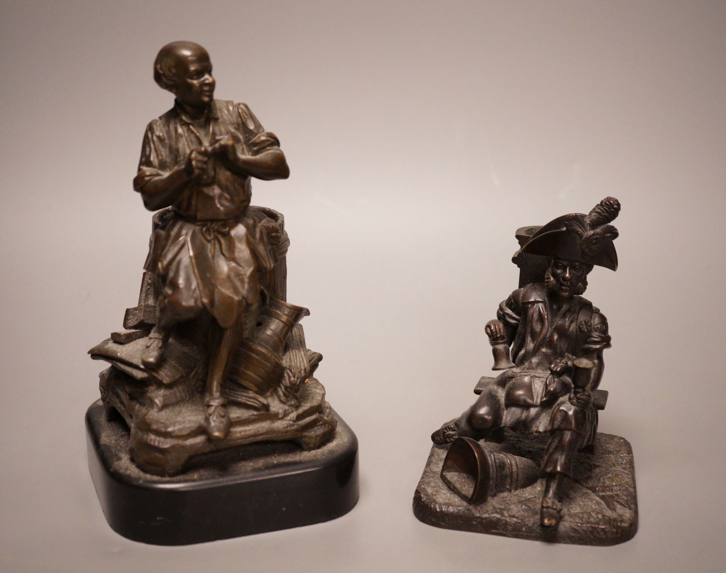 Two late 19th century bronze spill vases, cast as a tradesman and a war veteran. Tallest 19cm